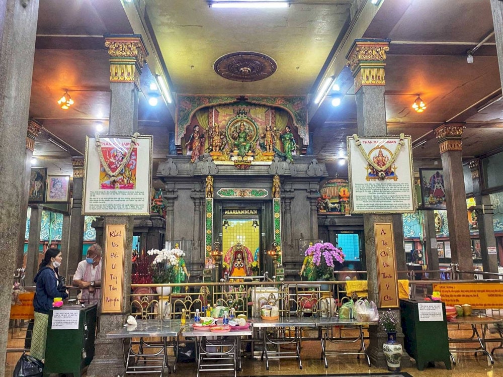 Inner sanctum with soft lighting, incense, and floral offerings creates a peaceful, sacred atmosphere